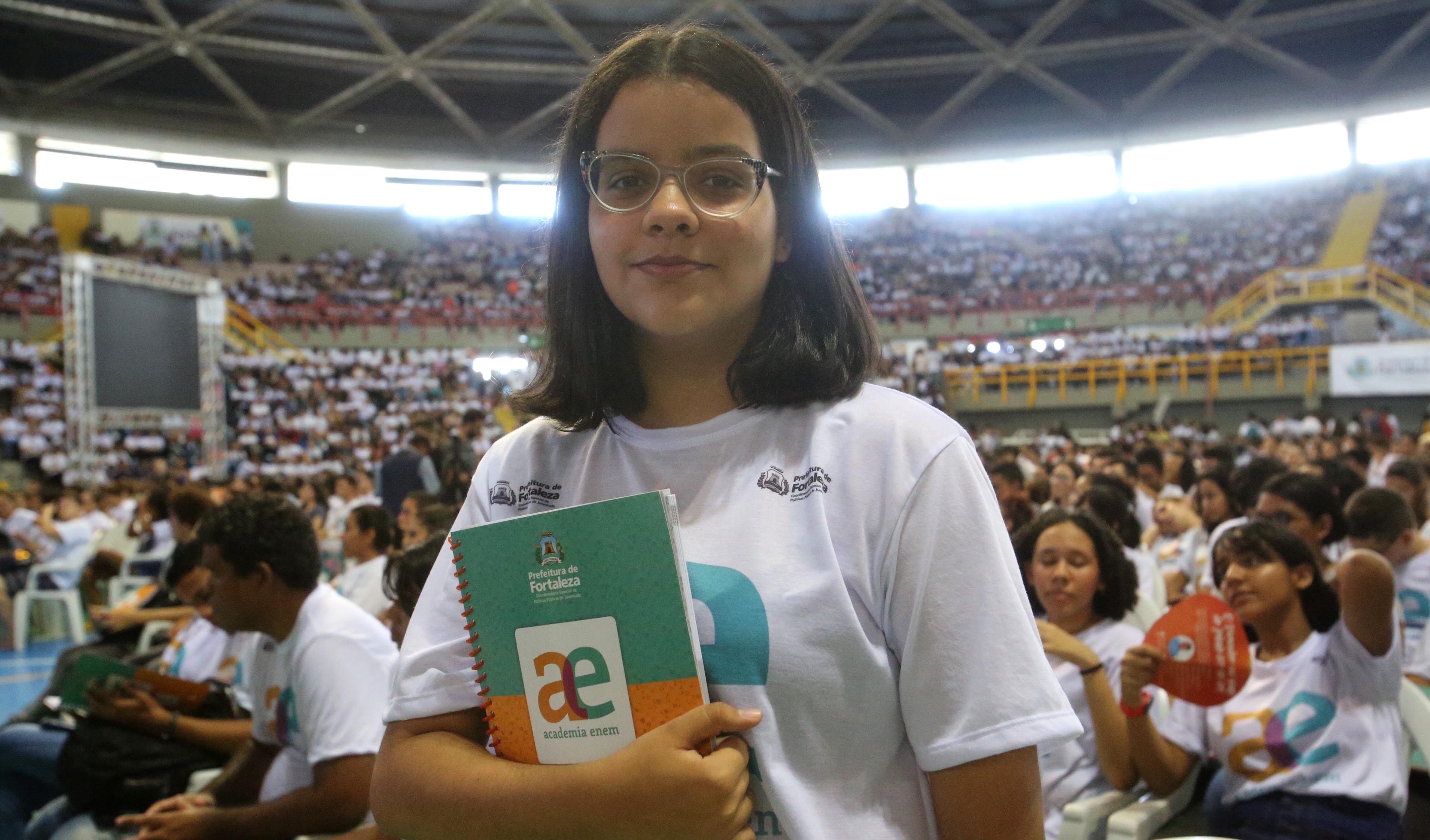 garota adolescente posando para a foto segurando livro